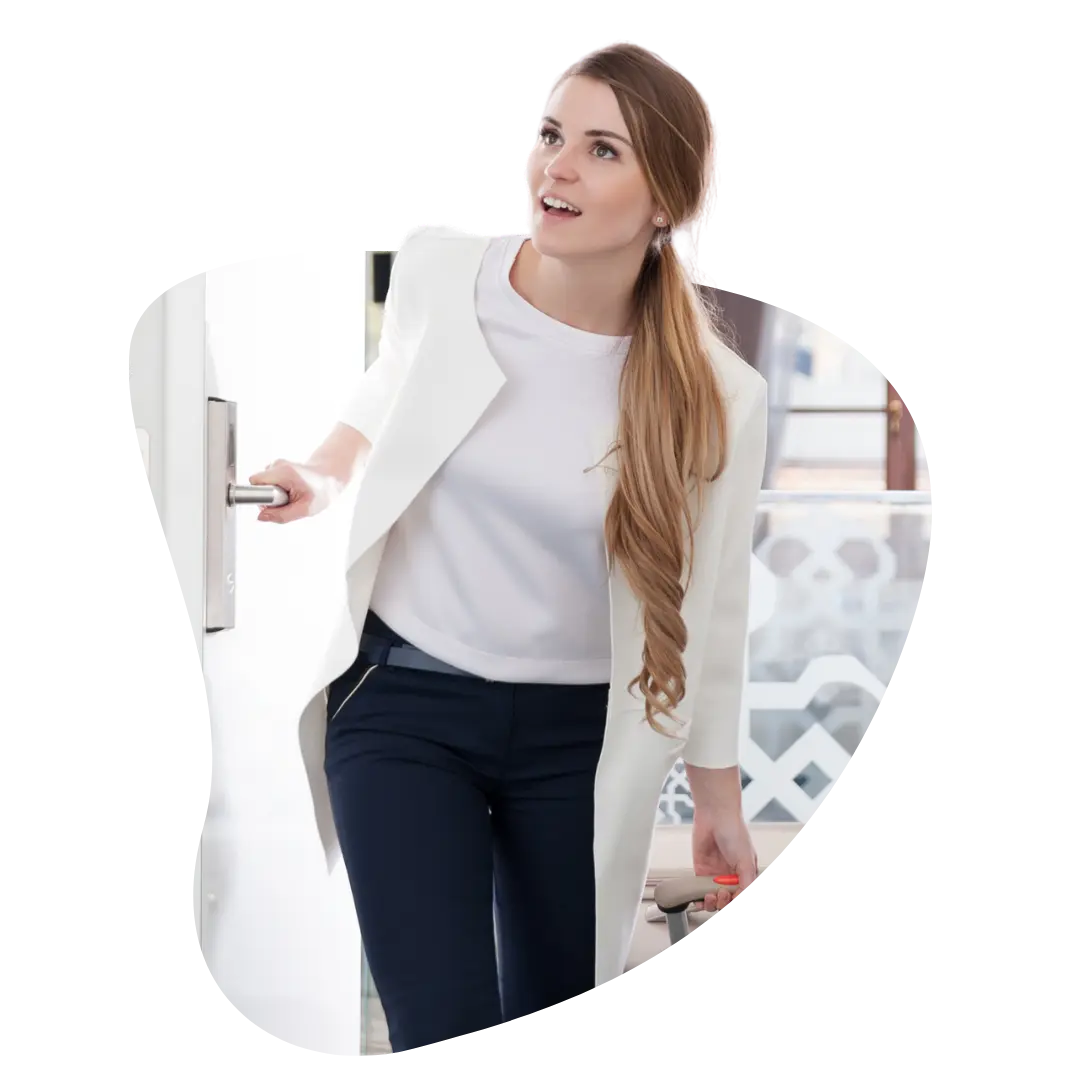 Hotel guest arriving and opening her room door, representing the missed moments when communications aren't sent on time
